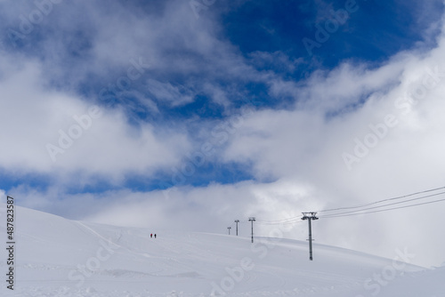 Image of a snow covered mountain plateau. Tourists walk and take pictures on a mountain plateau.