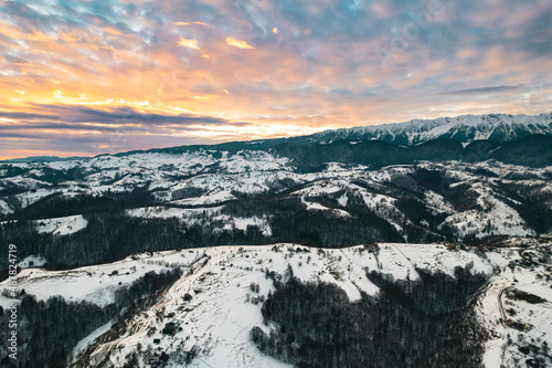 Spectacular sunset evening in Transylvania, Romania is the ideal time to go out and capture beautiful aerial photography. Sunset aerial with Moeciu and Bran in Brașov County, Transylvania, Romania