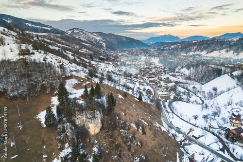 Sunset winter landscape from Transylvania Romania, Pestera Village in search for wilderness, nature, and countryside, along with backcountry road, more people are trying to reconnect with nature