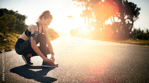 Lace up and get your head in the fitness game. Shot of a fit young woman tying her shoelaces before a run outdoors.