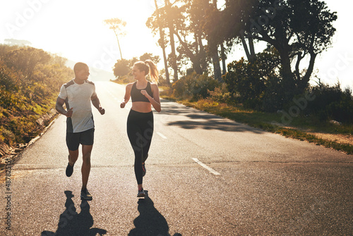 Getting the blood flowing with a workout buddy. Shot of a fit young couple going for a run outdoors. photo