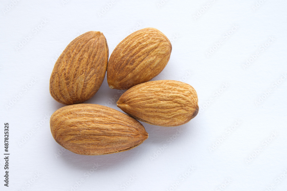 close up of raw peeled almonds seed isolated on white background, top view