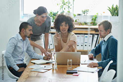 Failure is no option for this team. Shot of a group of professionals using wireless technology during a meeting.