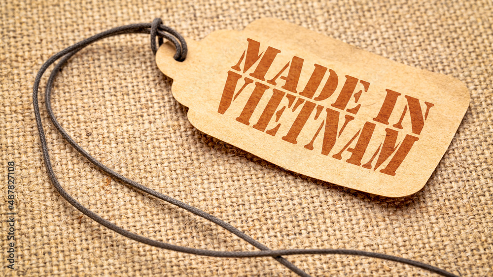 made in Vietnam sign red stencil text on a paper price tag against