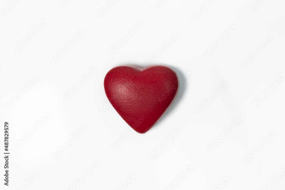 Chocolate candy in shape of a red heart.