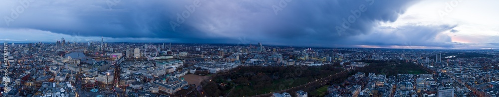 Aerial Panoramic view of London at dusk with storm clouds.