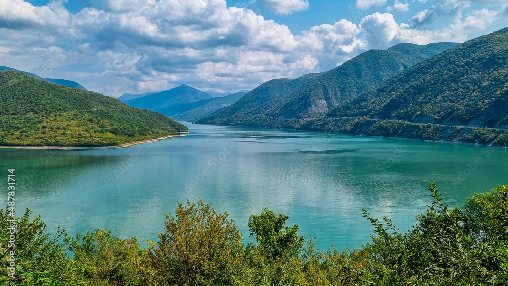 Zhinvali Reservoir. Beautiful mountain landscape. Ananuri lake with turquoise colored water surrounded by the Central Caucasus mountain ranges, Kazbegi Region in Georgia.Military road to Stepantsminda