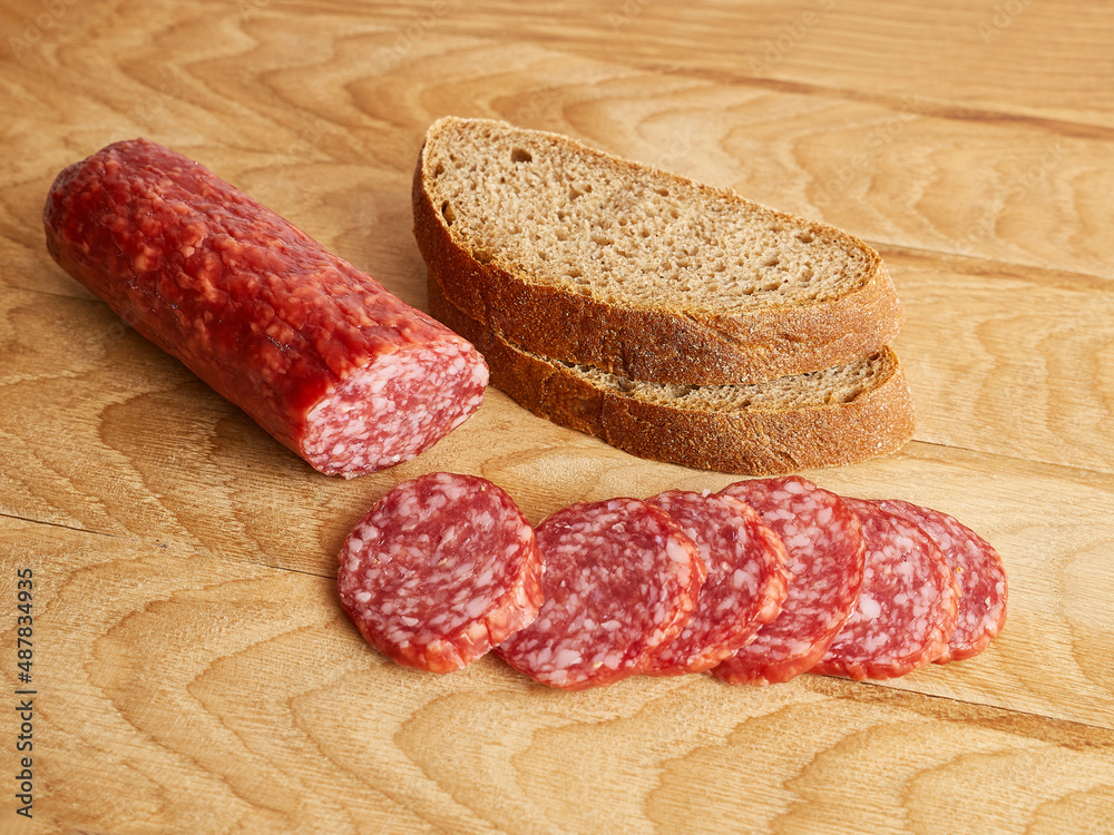 Making sandwiches from bread and sausage. Making sandwiches from bread and sausage.
