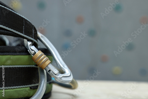 Climbing equipment on white table in gym, closeup. Space for text