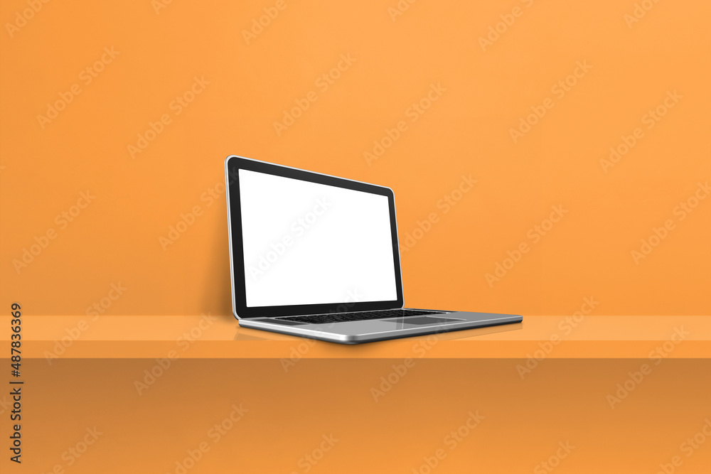 Laptop computer on orange shelf background