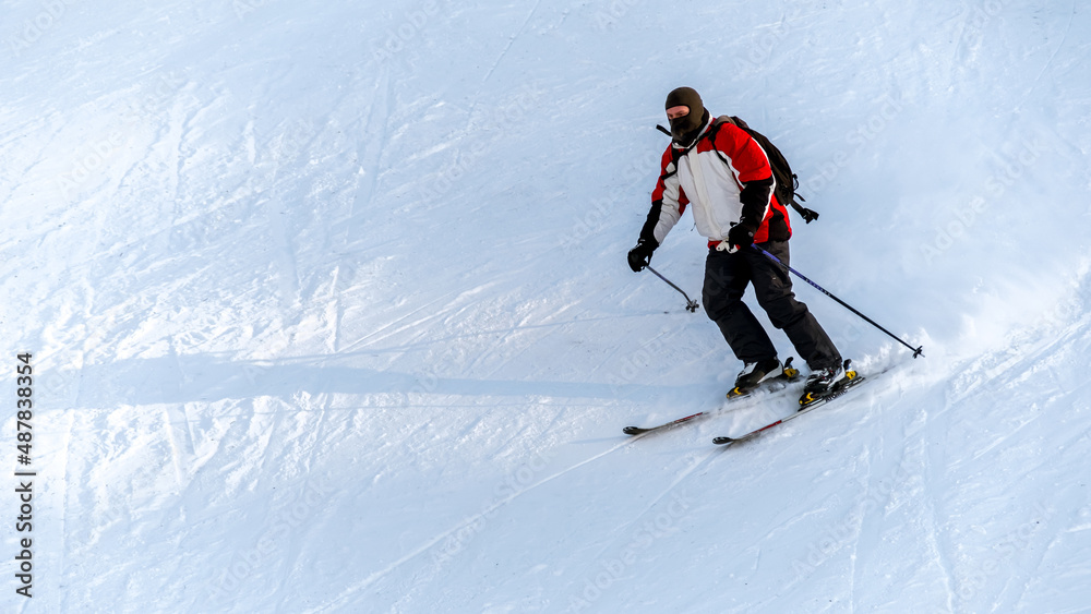Skier riding on a ski track in the Carpathians in winter, Romania