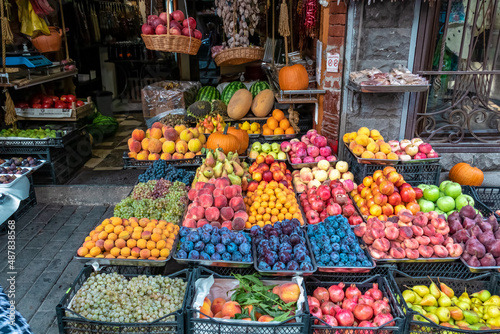 Various fruits for sale on a local outdoor market in the city center of Tbilisi, Georgia. Close View of fresh fruits in tray on showcase of local food market, Bazaar. Food tour. Vegetables and Fruits. © Chris