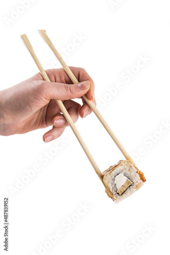 male caucasian hand holding chop sticks with one unagi maki roll sushi isolated on white background