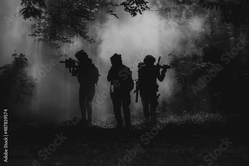 Military Historical reconstruction soldiers fighting during. US Army soldier soldiers in a cloud of smoke.