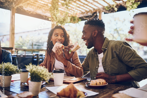 Theyre in the honeymoon stage of their relationship. Cropped shot of a happy young couple out for lunch at a cafe.