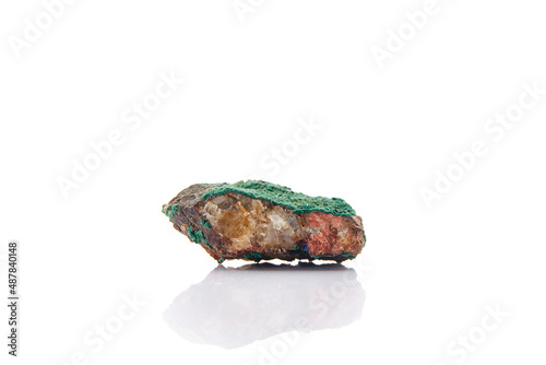 malachite formation on white background Malachite is a secondary ore of copper that is generally found in oxidized Cu deposits. It belongs to the monoclinic system and to the group of carbonates. photo