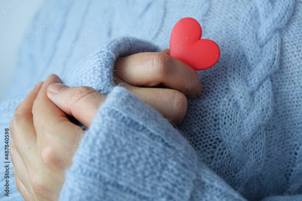 Red heart in female hands close up. The concept of health, love and charity. Red heart in female hands close up. The concept of health, love and charity.