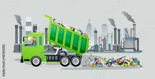 A worker in a garbage truck is pouring rubbish into a recycling plant.