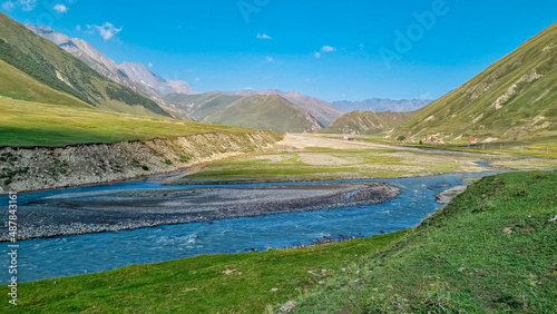 The Terek (Tergi) river flows down the Truso Valley near the Ketrisi Village Kazbegi District,Mtskheta in the Greater Caucasus Mountains,Georgia.Ketrisi village and Zakagori Fortress in the distance
