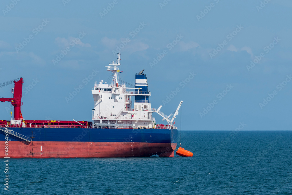Lowering and Maneuvering orange free fall lifeboat in water. Abandon ship drill. Lifeboat training. Lowering and Maneuvering orange free fall lifeboat in water. Abandon ship drill. Lifeboat training.