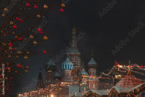 Festive decorations with new year's lights in front of St. Basil's Cathedral on Christmas Evening. Snowy Weather. Moscow, Russia, The Moscow Kremlin