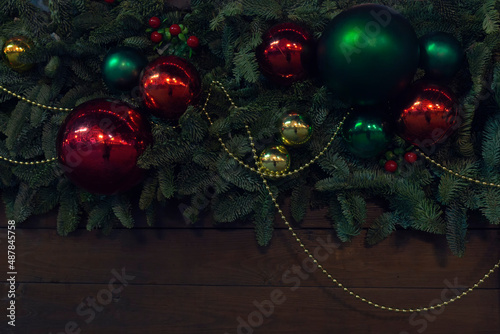 Close-up shot of christmas balls on a decorated fur-tree by winter evening
