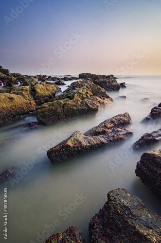Scenery of the beautiful sunset on a hazy day with silky water