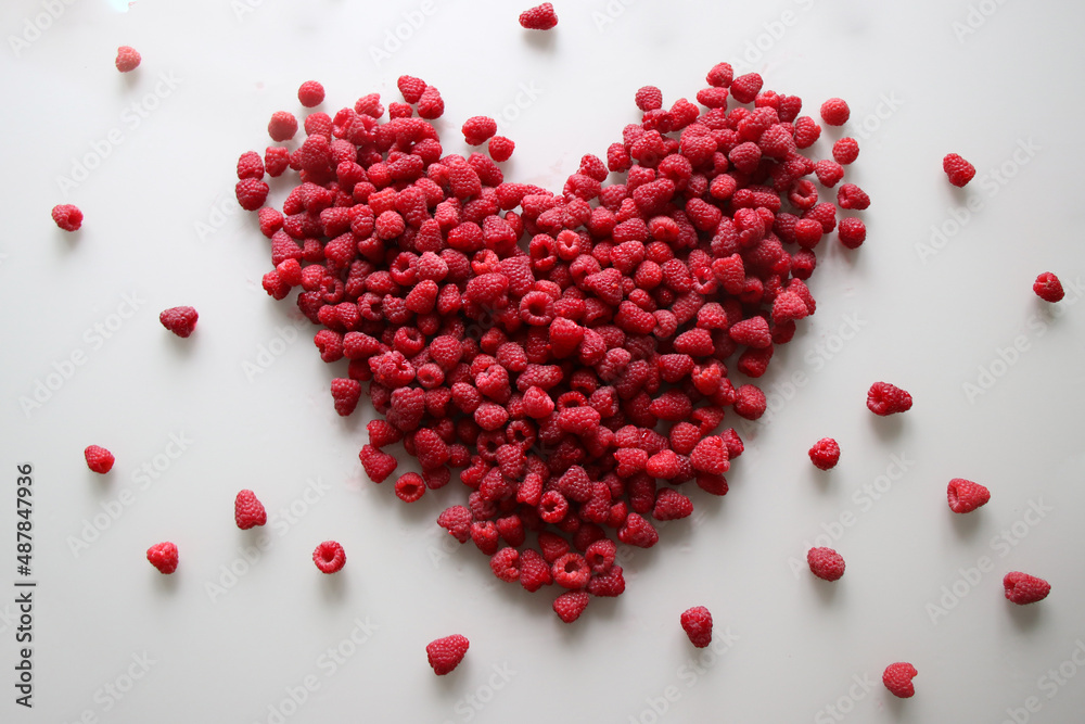 Fresh raspberries in the shape of a heart on a white background Fresh raspberries in the shape of a heart on a white background