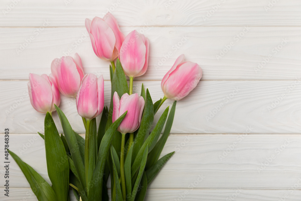 Pink tulips on a white wooden background.Side view. Spring bouquet.Holiday concept.Women's day, Valentine's day,Easter, birthday.Copy space. Pink tulips on a white wooden background.Side view. Spring bouquet.Holiday concept.Women's day, Valentine's day,Easter, birthday.Copy space.