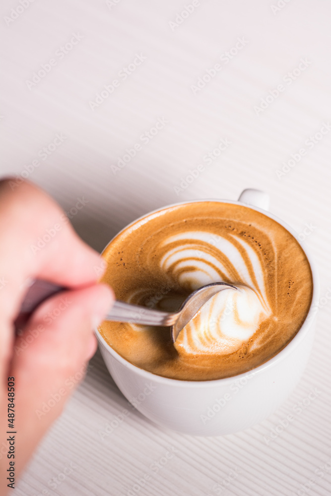 Cup of coffee with foamy milk. latte art. White mug. Breakfast

