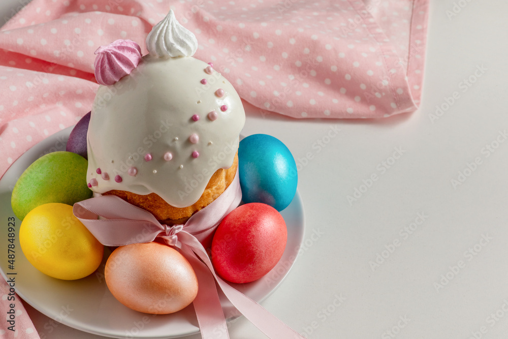 Easter cake, the traditional multi-colored eggs and pink cloth on the holiday table