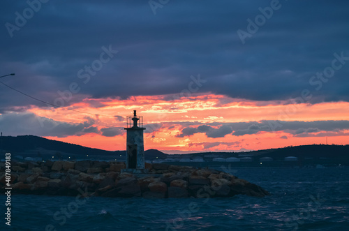 Lighthouse of harbour at sunset 