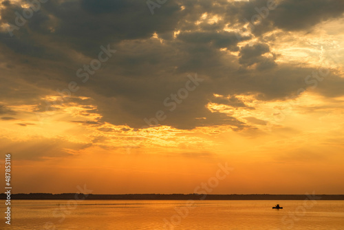 boat silhouette on the lake during sunset