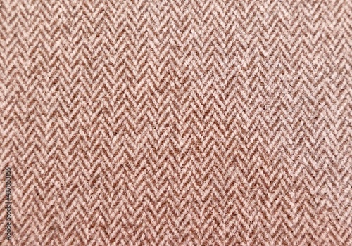 Full frame brown and white textured herringbone furnishing or fashion fabric