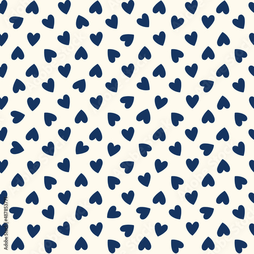 All over seamless vector repeat pattern with ditsy small navy blue hand drawn doodle hearts tossed as grid on cream. Simple cute Valentines day background