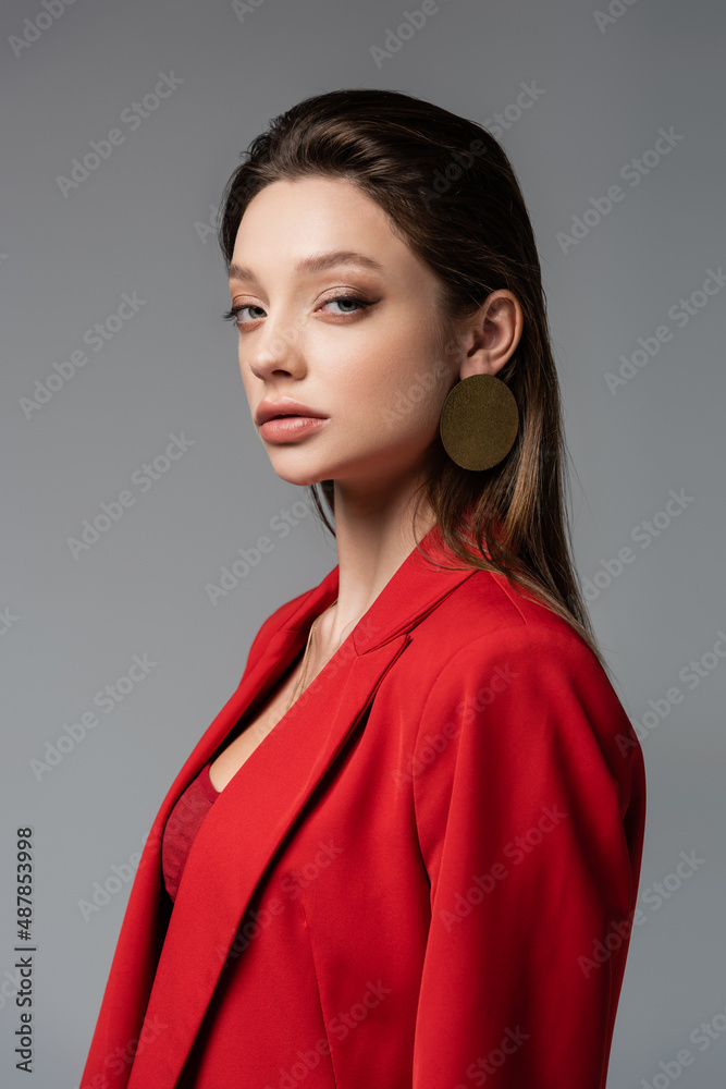 pretty woman in red blazer looking at camera isolated on grey. pretty woman in red blazer looking at camera isolated on grey.