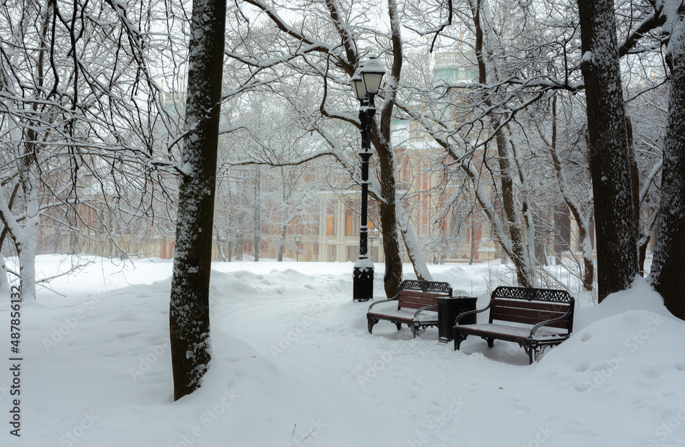 winter landscape, view on a bench and a lantern in the park,