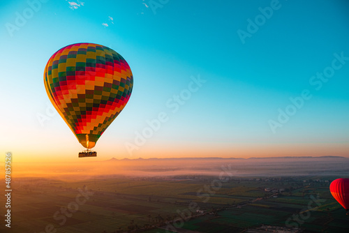 Amazing view of a vibrant colorful balloon at sunrise, flame firing to propel the balloon upwards. Balloon ride at luxor, egypt, famous in cappadocia