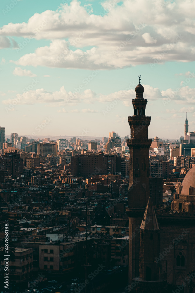 Vertical shot of Cairo rooftops, view from the Salah Al Din castle area. Mosqsue minaret in front, huge city and buildings going into the distance
