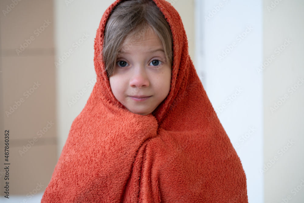 portrait of a little girl wrapped in a towel