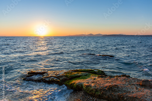 Beautiful sunset on the shore of a rocky sea beach  seascape