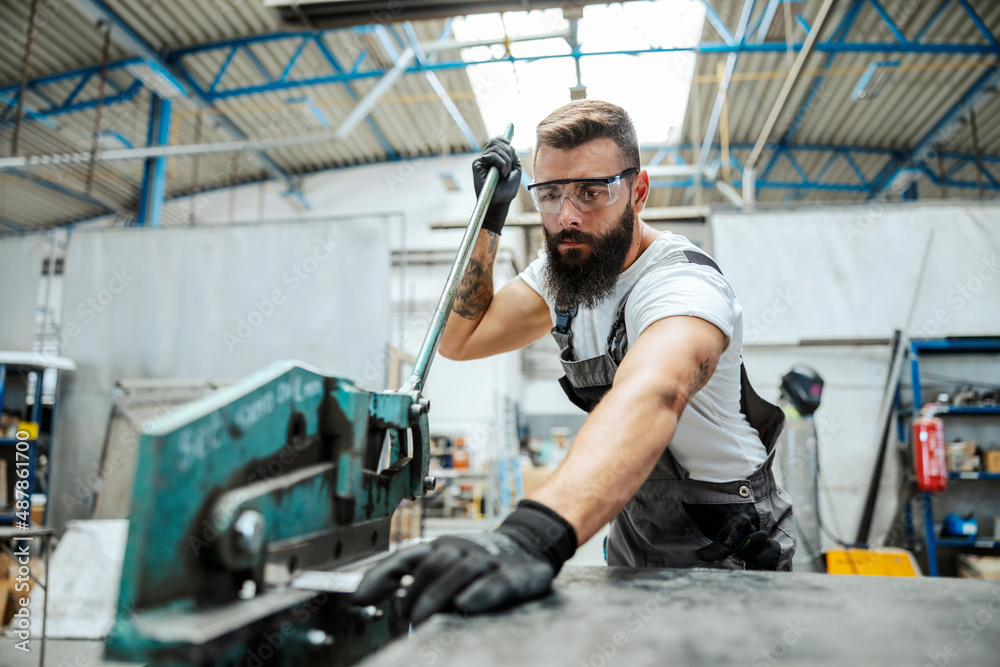 Worker doing metal jobs in the workshop.