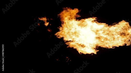 video with orange flame isolated on black background. Fire flow slow motion