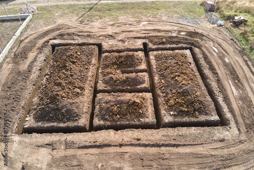 Dug out trench for building works of new house concrete foundation on construction site