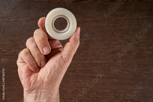 man's hand handing adhesive tapes