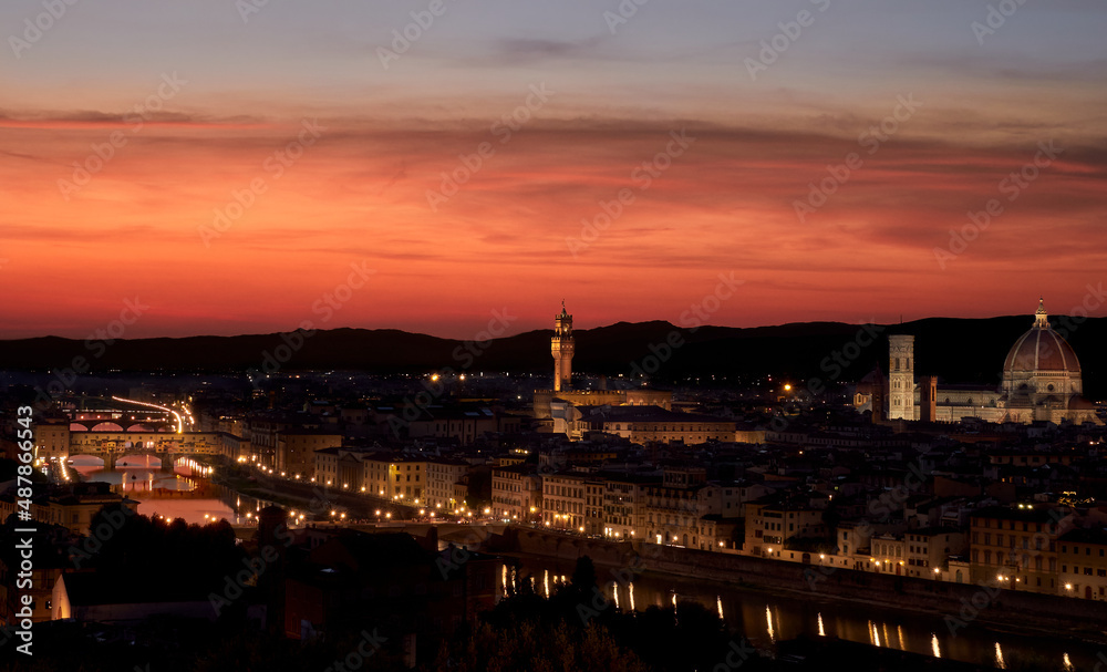 Panoramic view over Florence from the square at sunset with the red sky