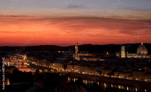 Panoramic view over Florence from the square at sunset with the red sky