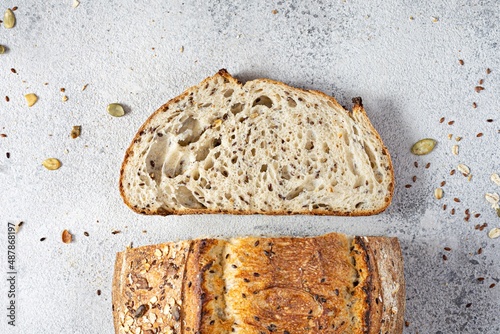 Fresh homemade bread (slice) from whole grain sourdough flour with the addition of bran, seeds (sunflower, pumpkin, flax, sesame) and oatmeal flakes. Healthy food. High quality photo. photo