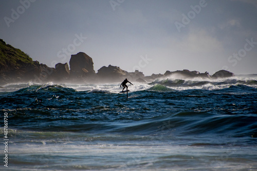 Foil surfer gliding over the water photo