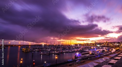 Sunset and clouds, marina with boats, vivid colors, Ponta Delgada, Azores.